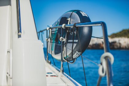 Jobe paddleboard stored on railing on a yacht